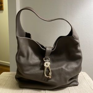 Dooney and Bourke logo lock bag in taupe